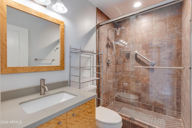 full bath featuring a stall shower, vanity, and toilet