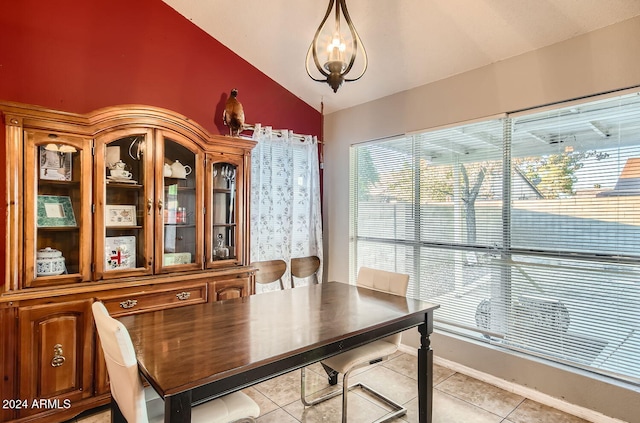 tiled dining room with lofted ceiling