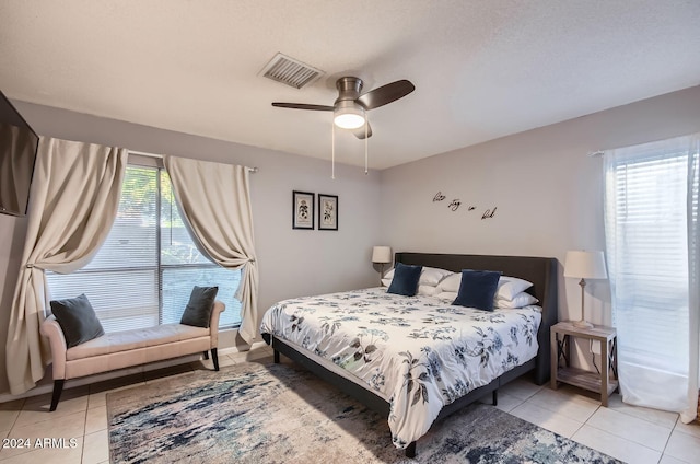 tiled bedroom with ceiling fan