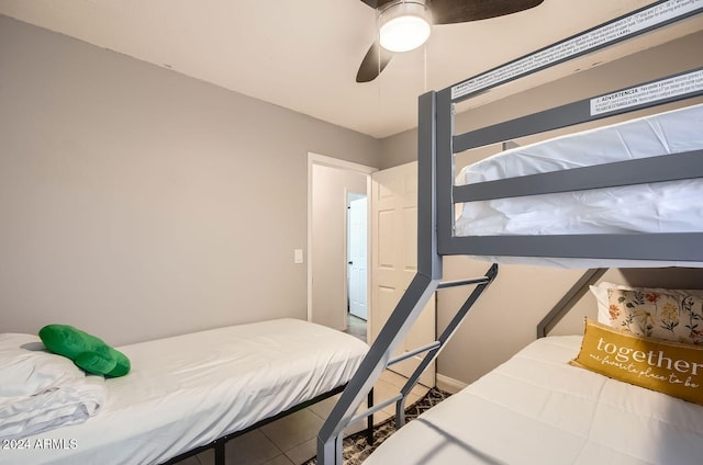 tiled bedroom featuring ceiling fan