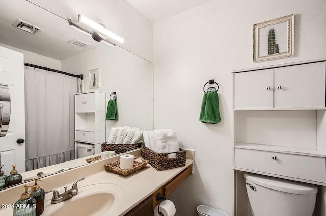 bathroom featuring vanity and toilet