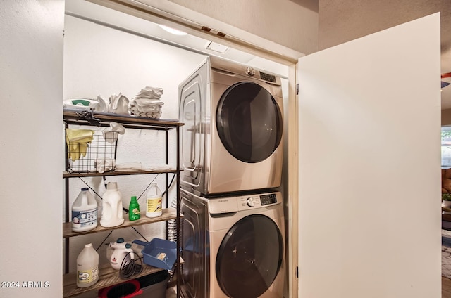 laundry area featuring stacked washer / drying machine