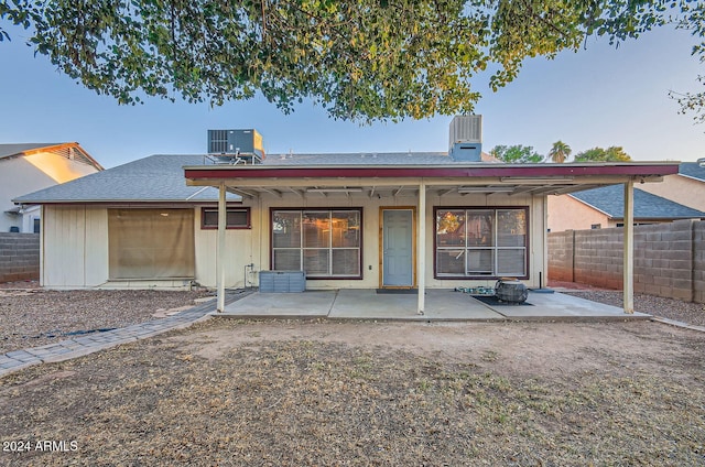 rear view of property featuring central AC unit and a patio area