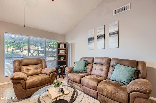 tiled living room with high vaulted ceiling