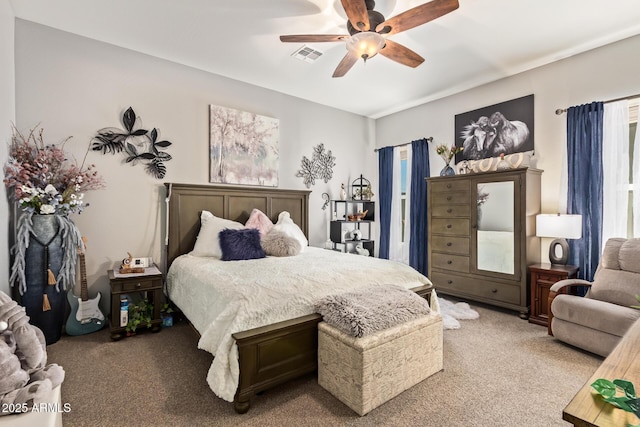 carpeted bedroom featuring a ceiling fan and visible vents