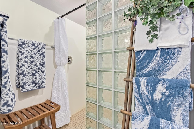bathroom featuring a walk in shower and tile patterned floors