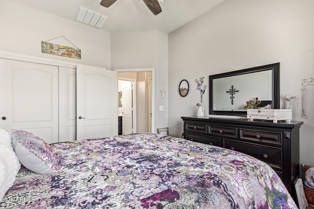 bedroom featuring ceiling fan, visible vents, vaulted ceiling, and a closet