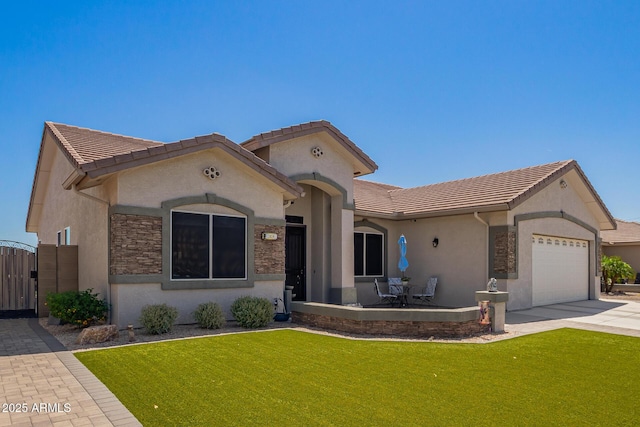 view of front of home with a garage, a front lawn, stucco siding, and driveway
