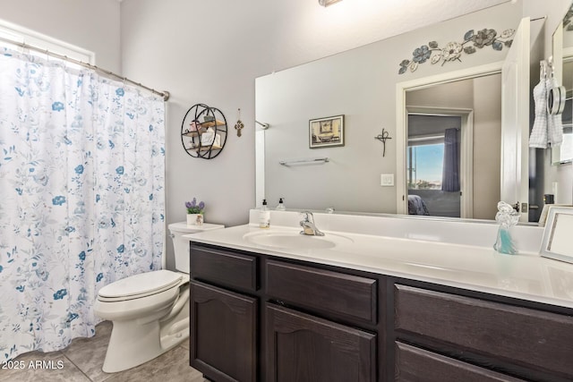 bathroom with toilet, curtained shower, tile patterned flooring, and vanity