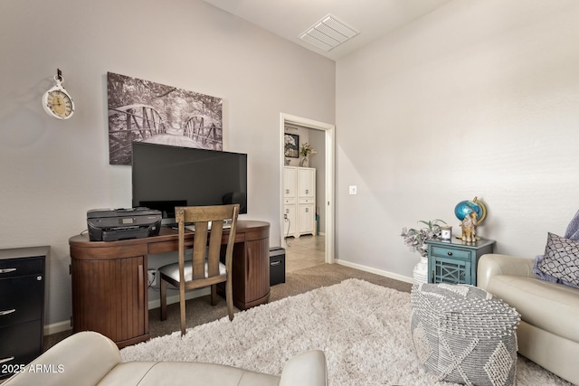 office area with baseboards, carpet flooring, and visible vents
