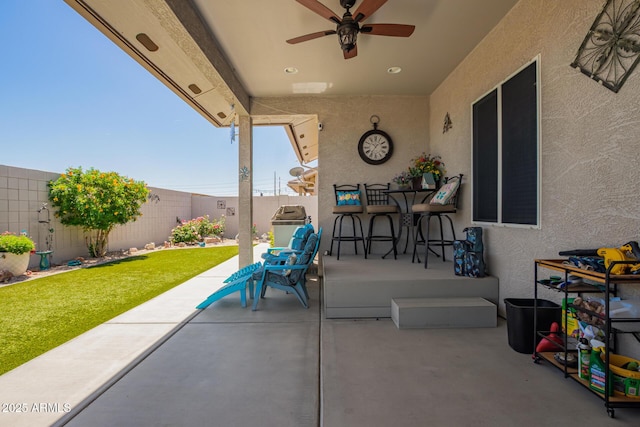 view of patio with a fenced backyard and ceiling fan