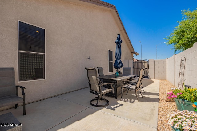 view of patio featuring a fenced backyard and outdoor dining area