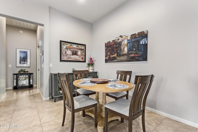 dining area with light tile patterned floors and baseboards