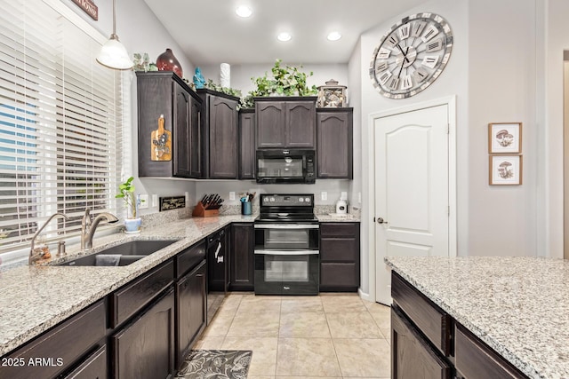kitchen featuring dark brown cabinetry, a sink, light stone counters, black appliances, and light tile patterned flooring