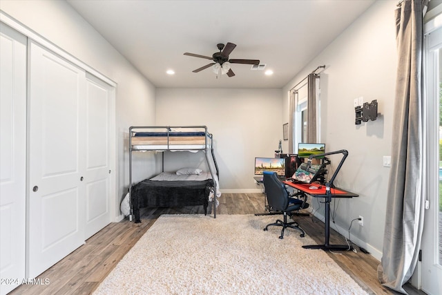 bedroom featuring light wood-type flooring and ceiling fan