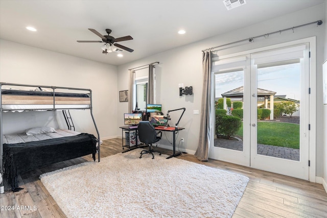 bedroom featuring ceiling fan, light hardwood / wood-style floors, access to exterior, and french doors