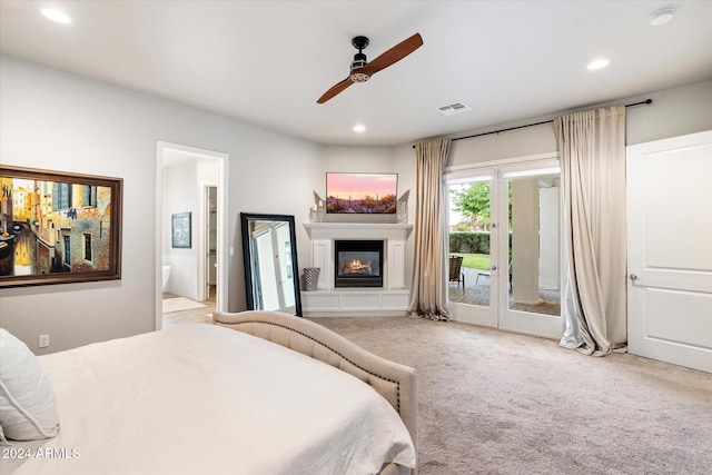 carpeted bedroom with access to outside, ensuite bath, and ceiling fan