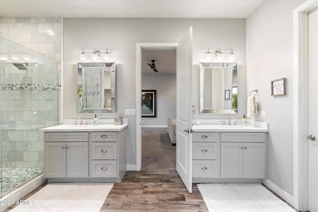 bathroom featuring vanity, wood-type flooring, and tiled shower