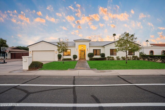 view of front of property with a lawn and a garage