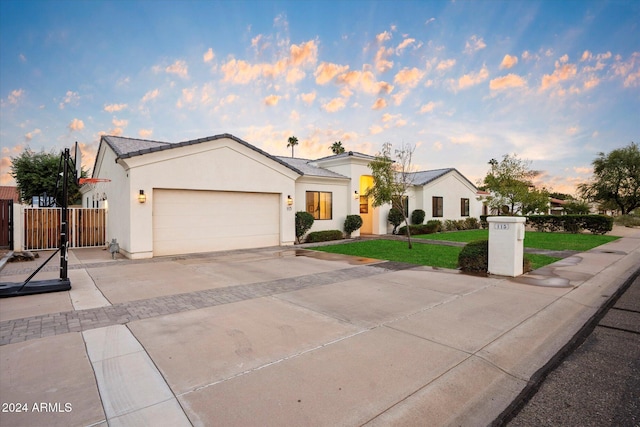 view of front of home with a front yard and a garage