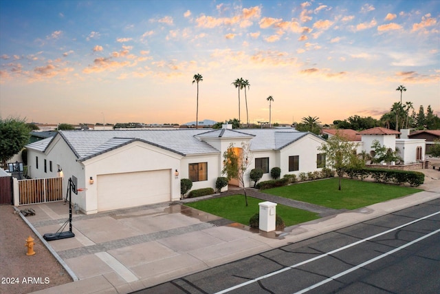 view of front of property featuring a yard and a garage