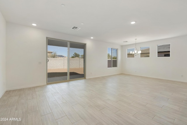 unfurnished room with a chandelier, baseboards, visible vents, and recessed lighting