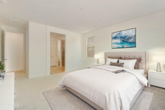 bedroom with visible vents and light colored carpet