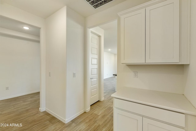hall with recessed lighting, visible vents, baseboards, and light wood-style flooring