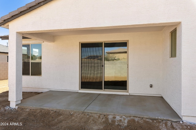 exterior space featuring a patio area and stucco siding