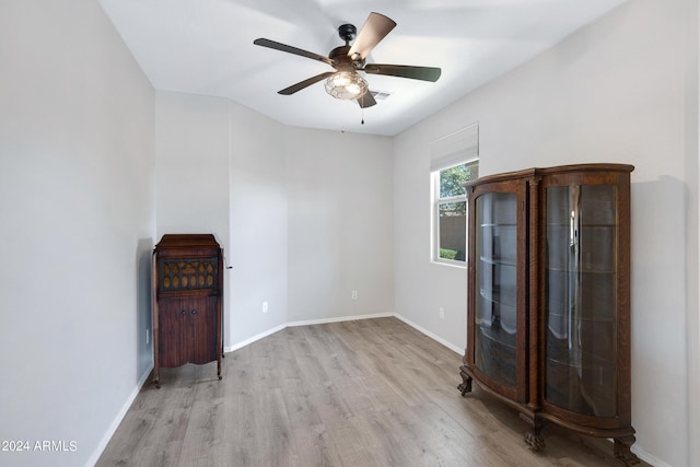 unfurnished living room featuring light hardwood / wood-style flooring and ceiling fan