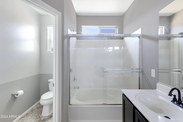 full bathroom featuring bath / shower combo with glass door, toilet, and vanity