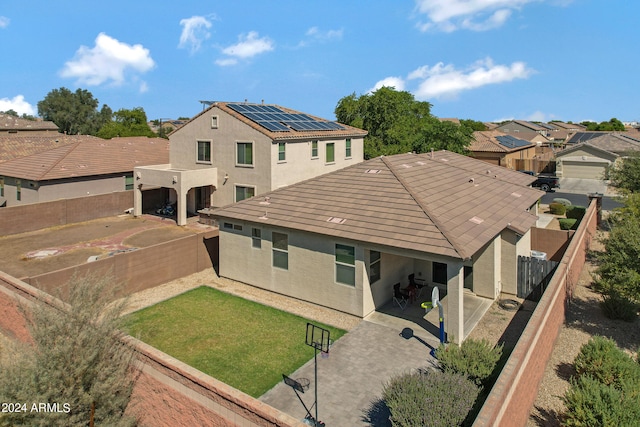 back of house with a yard and a garage