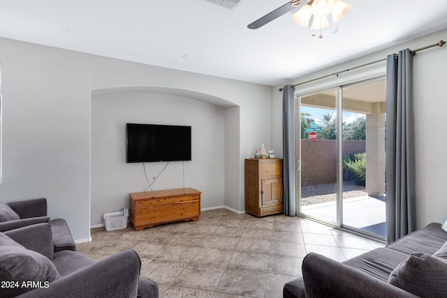 living room featuring light tile patterned floors and ceiling fan