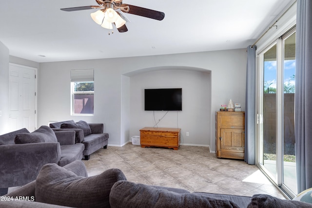 living room with light tile patterned flooring and ceiling fan