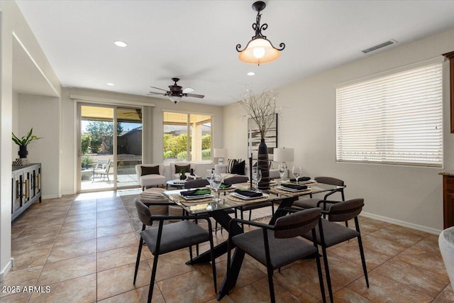 tiled dining space with ceiling fan