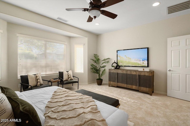 bedroom featuring light colored carpet and ceiling fan