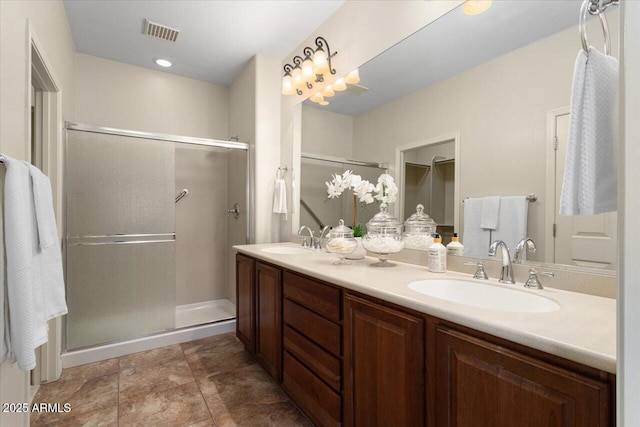 bathroom with vanity and a shower with shower door