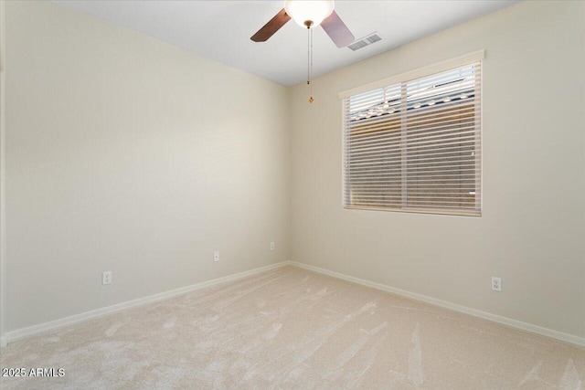 carpeted spare room with ceiling fan