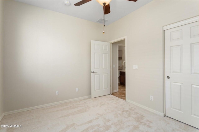 unfurnished bedroom with ceiling fan, a closet, and light colored carpet