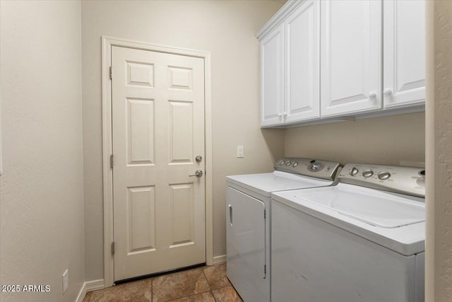 clothes washing area with washer and clothes dryer and cabinets