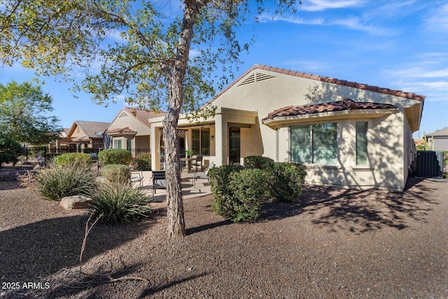 view of front of property with central AC unit and a patio