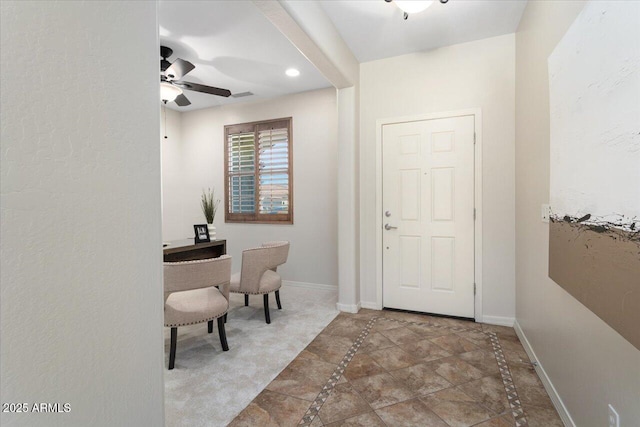 entryway with ceiling fan and tile patterned flooring