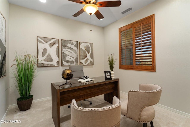 carpeted office space featuring ceiling fan