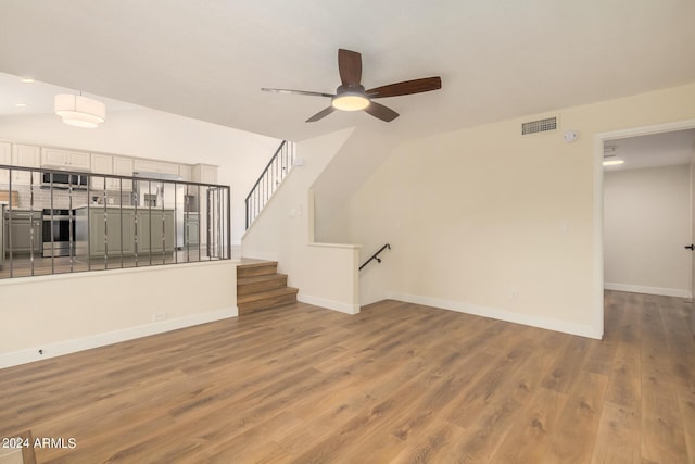 unfurnished living room with wood-type flooring, ceiling fan, and lofted ceiling