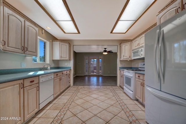 kitchen featuring ceiling fan, light tile patterned flooring, and white appliances