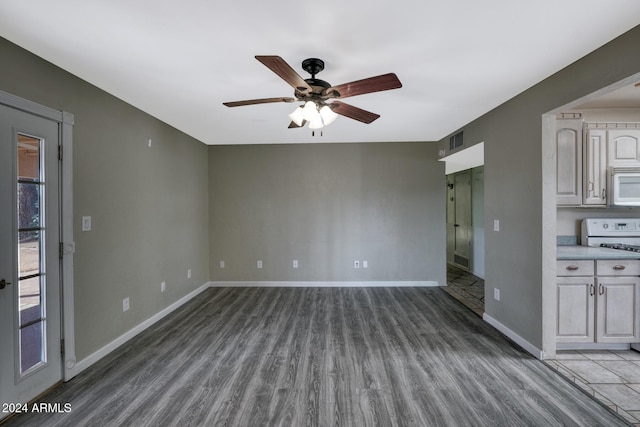 unfurnished living room featuring ceiling fan and wood-type flooring