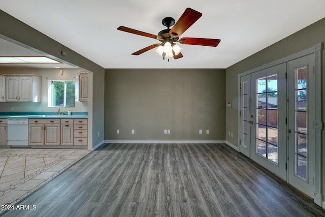 interior space featuring ceiling fan, wood-type flooring, and sink