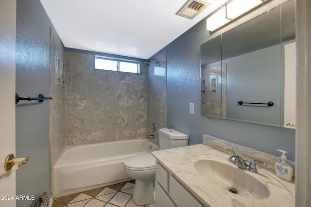 full bathroom featuring tile patterned floors, vanity, toilet, and tiled shower / bath combo