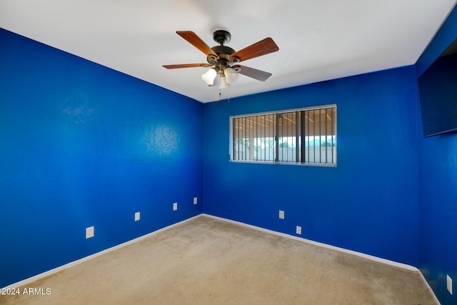 unfurnished room featuring carpet and ceiling fan