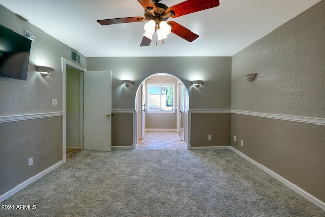 empty room with light carpet and ceiling fan